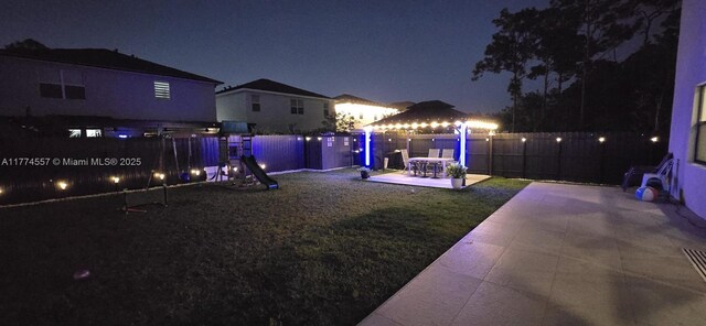 12973SW 266th Ter, Homestead, FL 33032 - yard at night with a patio area