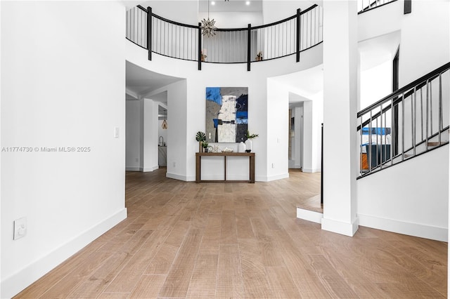 7767 SW 188th St, Cutler Bay, FL 33157 - foyer featuring a towering ceiling, baseboards, stairs, and wood finished floors