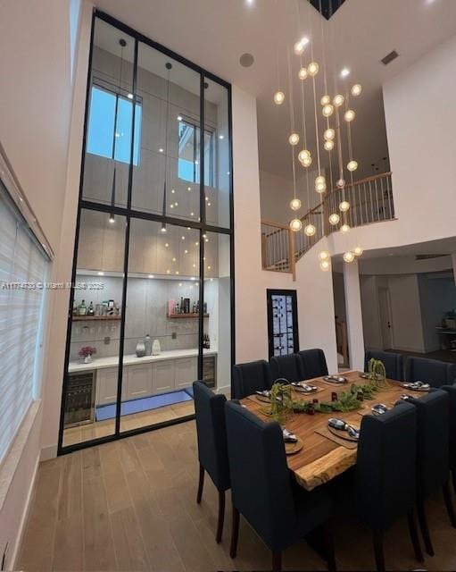 7767 SW 188th St, Cutler Bay, FL 33157 - dining room featuring a high ceiling, wood finished floors, and a chandelier
