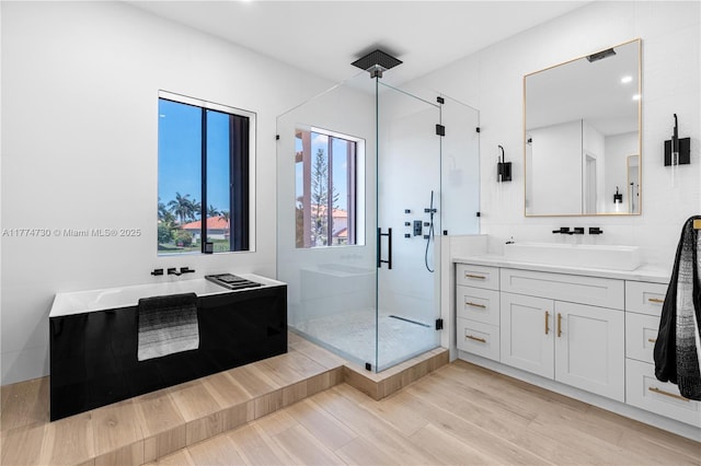 7767 SW 188th St, Cutler Bay, FL 33157 - bathroom featuring a stall shower, vanity, wood finished floors, and a tub to relax in
