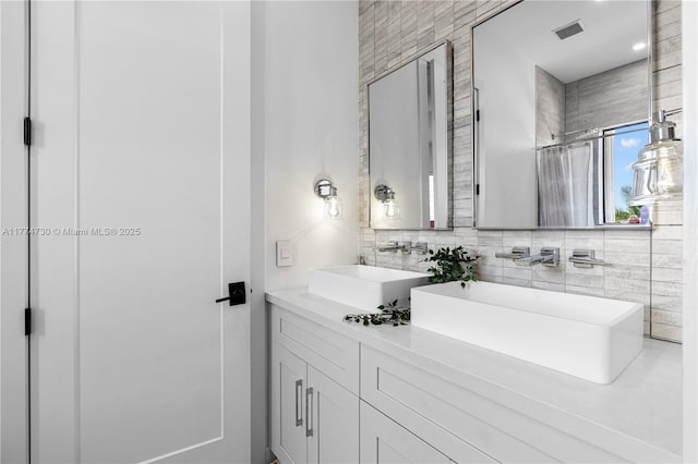 7767 SW 188th St, Cutler Bay, FL 33157 - full bathroom featuring double vanity and decorative backsplash