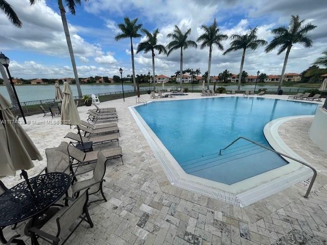 7767 SW 188th St, Cutler Bay, FL 33157 - community pool featuring a patio area, fence, and a water view