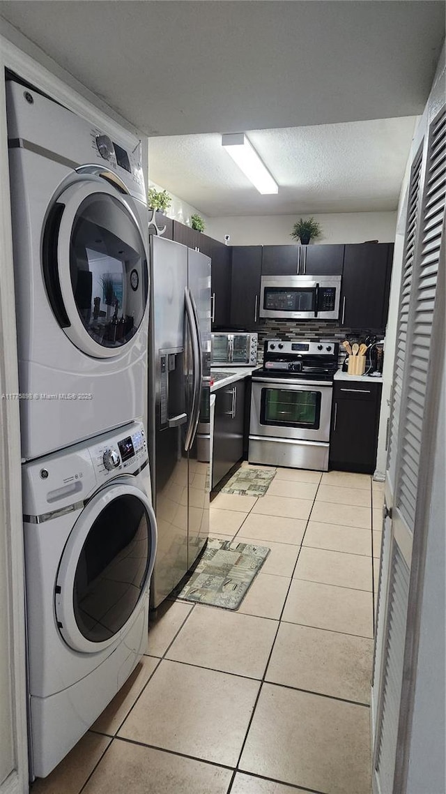 8254 SW 147th Pl, Miami, FL 33193 - washroom with estacked washer and dryer and light tile patterned flooring