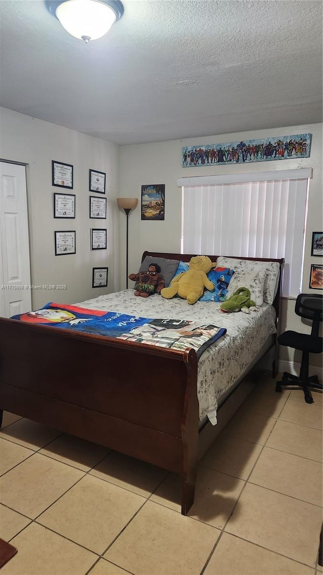 8254 SW 147th Pl, Miami, FL 33193 - bedroom with light tile patterned floors and a textured ceiling