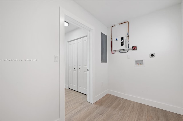 laundry area with electric panel, hookup for an electric dryer, baseboards, light wood-style floors, and hookup for a washing machine