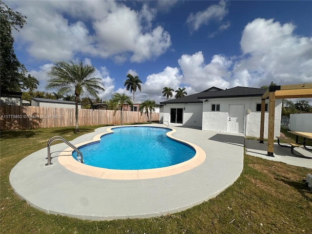 view of pool featuring fence, a yard, a patio, and a fenced in pool