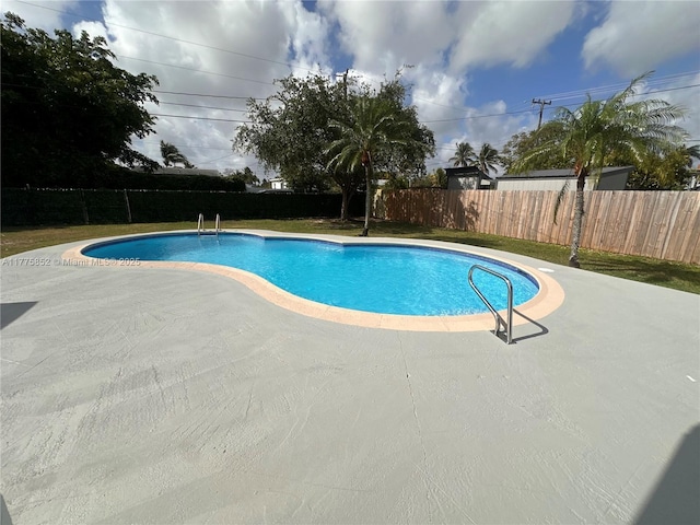 view of swimming pool with a fenced backyard, a patio, and a fenced in pool