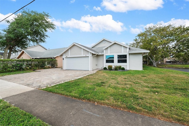 3185 NW 120th Way, Sunrise, FL 33323 - view of front of house with a front yard, an attached garage, decorative driveway, and stucco siding