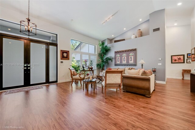 9030 SW 92nd Ct, Miami, FL 33176 - living room featuring baseboards, high vaulted ceiling, visible vents, and wood finished floors