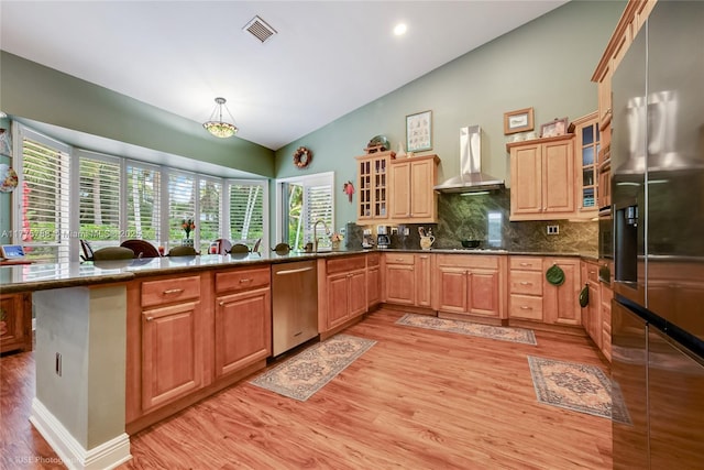 9030 SW 92nd Ct, Miami, FL 33176 - kitchen featuring tasteful backsplash, vaulted ceiling, a peninsula, appliances with stainless steel finishes, and wall chimney exhaust hood