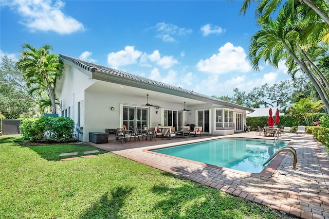9030 SW 92nd Ct, Miami, FL 33176 - back of property featuring a lawn, ceiling fan, stucco siding, and a patio