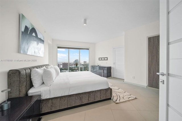 60 SW 13th St Unit 2600, Miami, FL 33130 - bedroom with light tile patterned flooring, access to exterior, and a city view