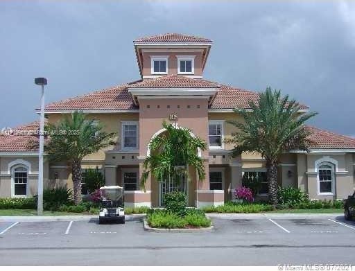 6434 Emerald Dunes Dr Unit 202, West Palm Beach, FL 33411 - view of building exterior with uncovered parking