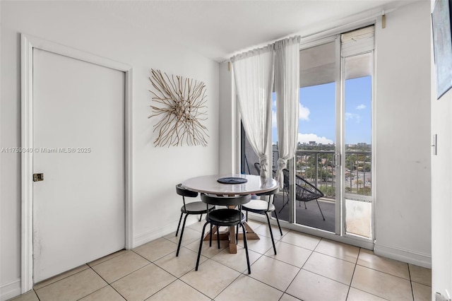 1 Glen Royal Pkwy Unit 1207, Miami, FL 33125 - dining space with baseboards, expansive windows, light tile patterned floors, and a city view