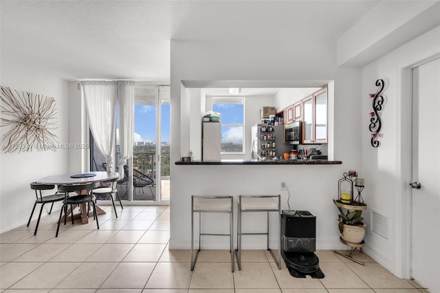 1 Glen Royal Pkwy Unit 1207, Miami, FL 33125 - kitchen featuring light tile patterned flooring, visible vents, dark countertops, and appliances with stainless steel finishes
