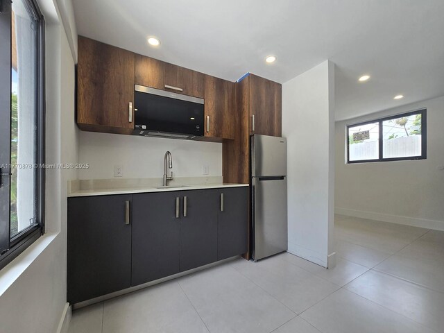 5152 SW 6th, Miami, FL 33134 - kitchen with freestanding refrigerator, a sink, light countertops, recessed lighting, and baseboards