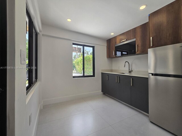 5152 SW 6th, Miami, FL 33134 - kitchen featuring freestanding refrigerator, light countertops, a sink, recessed lighting, and light tile patterned floors