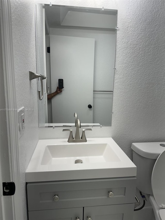 1611 NE 32nd Pl, Pompano Beach, FL 33064 - half bath with toilet, vanity, and a textured wall