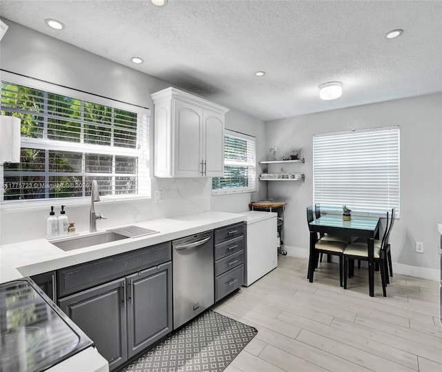 217 SE 5th St, Dania Beach, FL 33004 - kitchen with dishwasher, a sink, white cabinets, gray cabinets, and light countertops