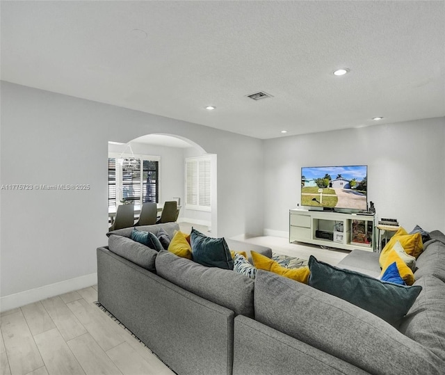217 SE 5th St, Dania Beach, FL 33004 - living room featuring arched walkways, recessed lighting, baseboards, and a textured ceiling