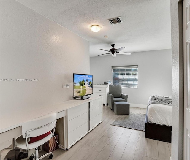 217 SE 5th St, Dania Beach, FL 33004 - bedroom featuring light wood-style flooring, a textured ceiling, a ceiling fan, and baseboards