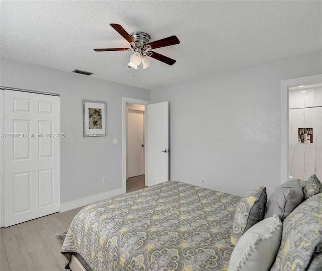 217 SE 5th St, Dania Beach, FL 33004 - bedroom featuring ceiling fan, a textured ceiling, and light wood finished floors