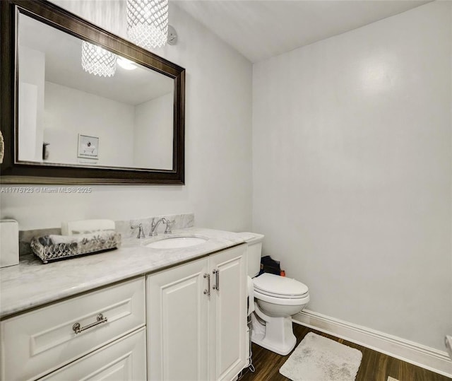 217 SE 5th St, Dania Beach, FL 33004 - bathroom with toilet, vanity, wood finished floors, and baseboards