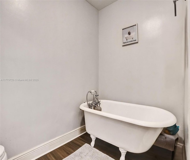 217 SE 5th St, Dania Beach, FL 33004 - full bathroom with baseboards, wood finished floors, and a freestanding bath