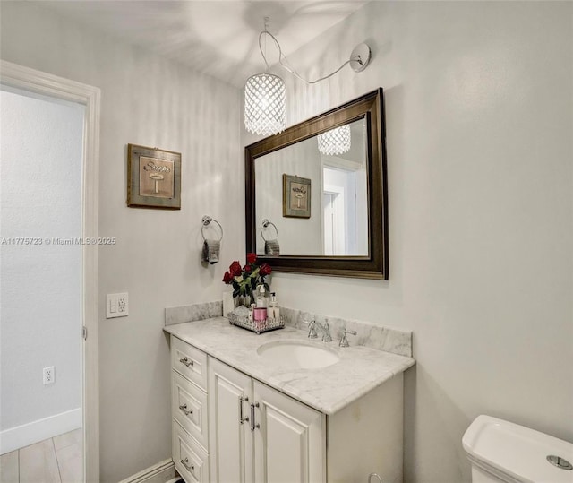 217 SE 5th St, Dania Beach, FL 33004 - bathroom featuring vanity, toilet, and baseboards