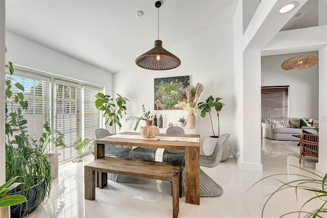 dining area with baseboards and light tile patterned floors