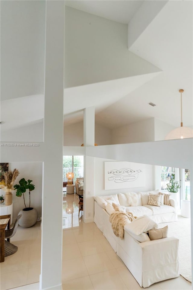 bedroom with high vaulted ceiling, light tile patterned flooring, and visible vents