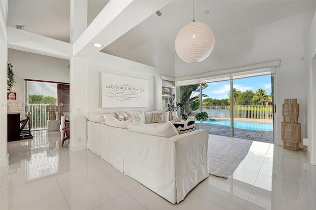 1055 San, Luis Rey, Weston, FL 33326 - living area featuring high vaulted ceiling, light tile patterned floors, and baseboards