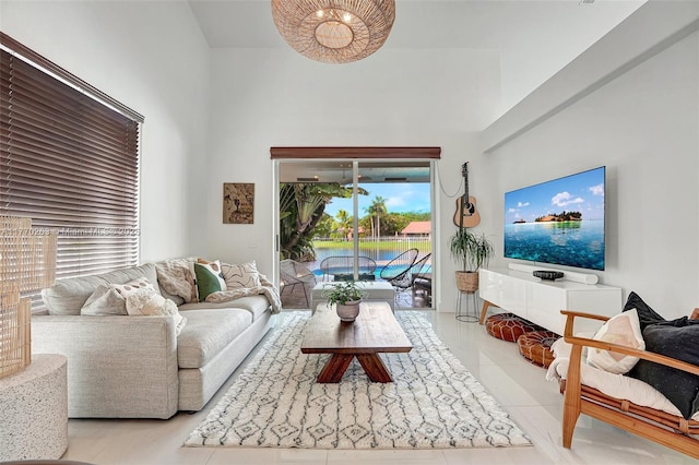 living area featuring tile patterned flooring and a high ceiling