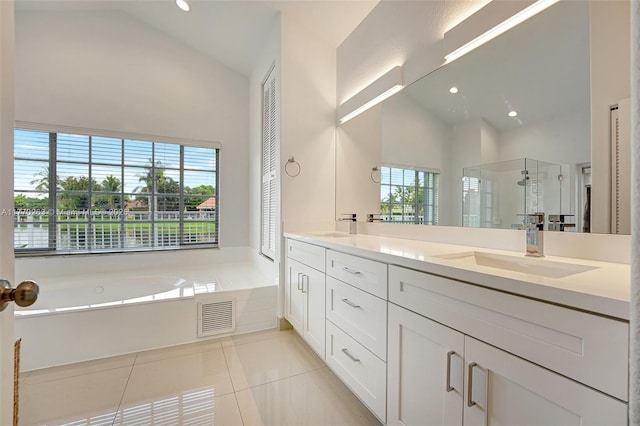 full bath featuring visible vents, a sink, a stall shower, and a wealth of natural light