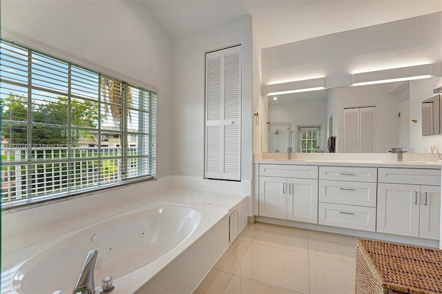 bathroom featuring a whirlpool tub, a closet, and a wealth of natural light