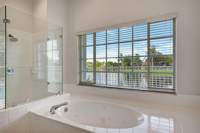 full bathroom with a whirlpool tub and a tile shower