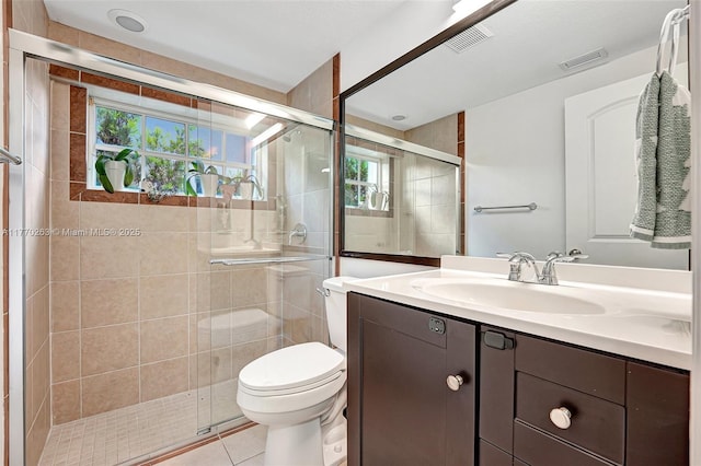 bathroom with toilet, visible vents, a healthy amount of sunlight, and a stall shower