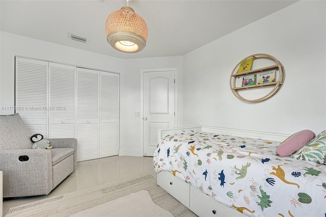 bedroom featuring visible vents, tile patterned floors, and a closet