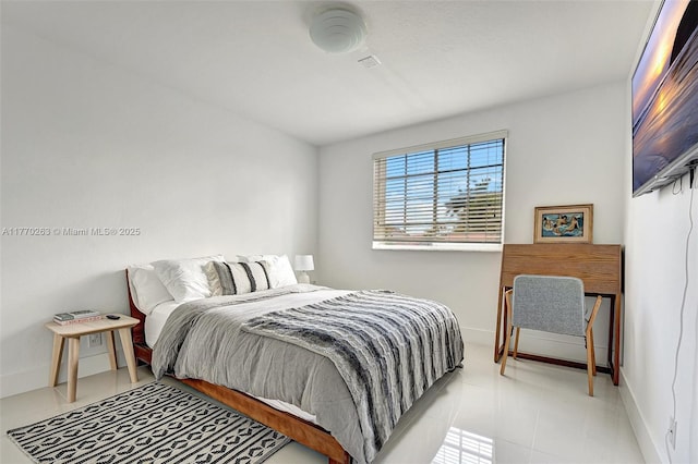 bedroom featuring baseboards and tile patterned flooring