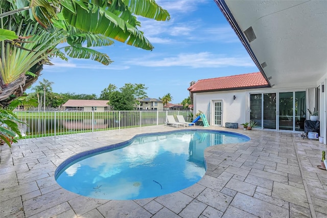 view of pool with a fenced backyard, a fenced in pool, and a patio area