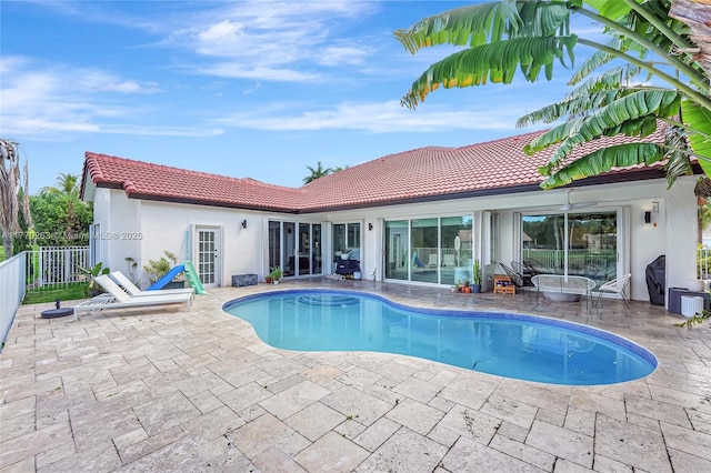 view of swimming pool featuring fence, a fenced in pool, and a patio area