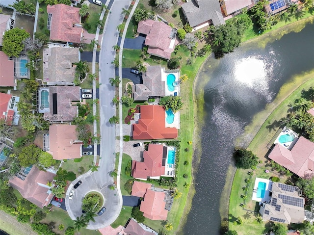birds eye view of property with a water view and a residential view