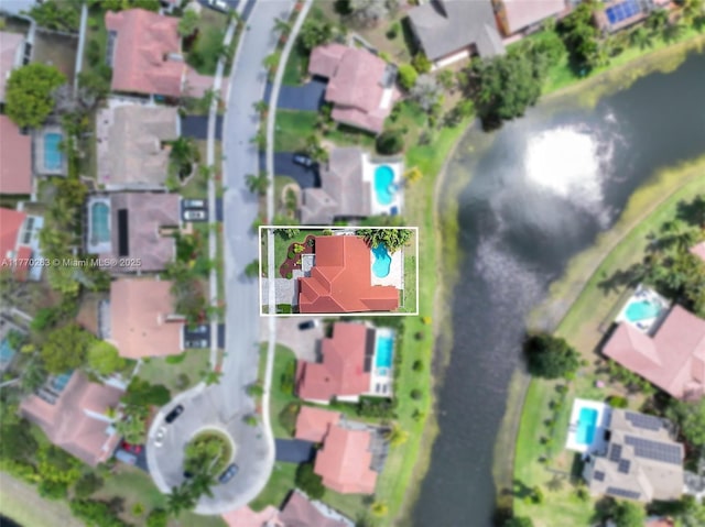 birds eye view of property with a water view and a residential view