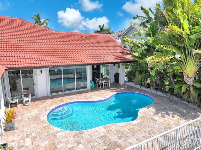 outdoor pool with a patio area