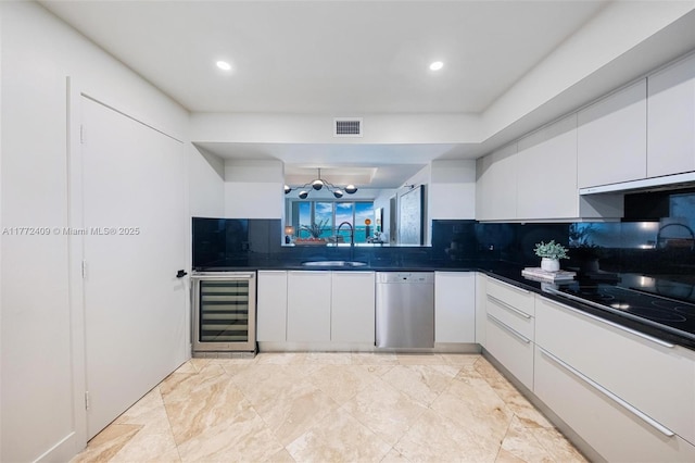 1331 Brickell Bay Dr Unit 3305, Miami, FL 33131 - kitchen featuring wine cooler, stainless steel dishwasher, dark countertops, white cabinets, and decorative backsplash