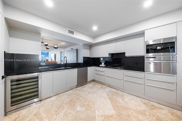 1331 Brickell Bay Dr Unit 3305, Miami, FL 33131 - kitchen with a warming drawer, wine cooler, dark countertops, stainless steel dishwasher, and white cabinetry