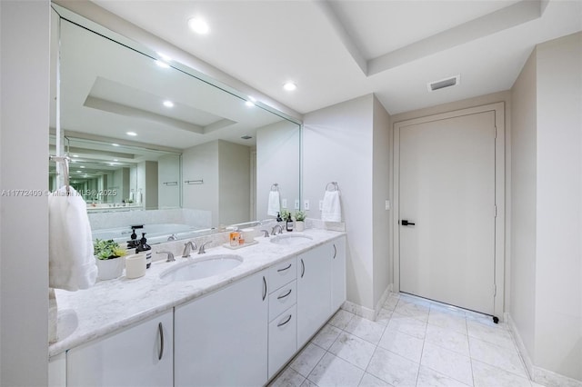 1331 Brickell Bay Dr Unit 3305, Miami, FL 33131 - bathroom featuring a raised ceiling, double vanity, and recessed lighting