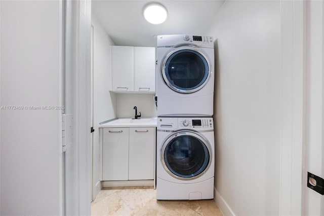 1331 Brickell Bay Dr Unit 3305, Miami, FL 33131 - laundry room featuring cabinet space, stacked washer / dryer, and light tile patterned flooring