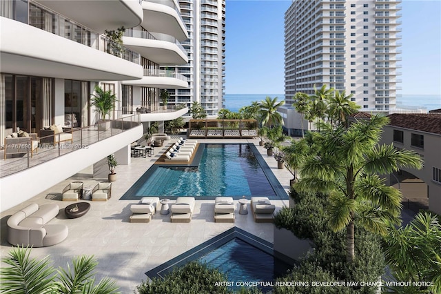 pool featuring a water view and a patio area