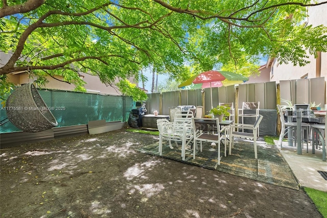 view of patio featuring a fenced backyard and outdoor dining space